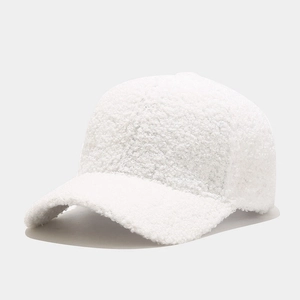 Close-up of the plush white sherpa fleece texture on a warm winter baseball cap