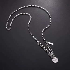 Silver layered titanium steel necklace with checkerboard chain and circular quote pendant