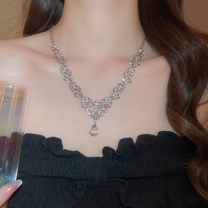 Elegant leaf flower necklace featuring a pink pear-shaped pendant on a female model