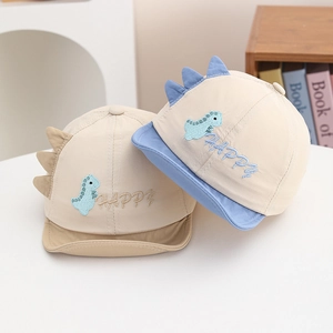 Detailed view of baby sun cap featuring dinosaur embroidery and 3D decorative back fins