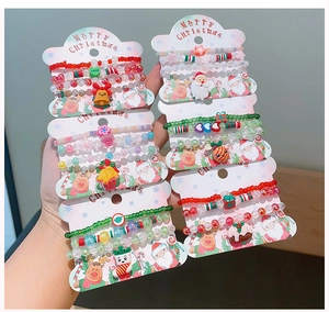 Close-up of colorful handmade Christmas beaded bracelets with festive charms and packaging