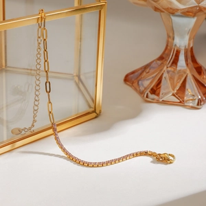 18K gold plated stainless steel bracelet featuring pink gemstones on a glass jewelry box