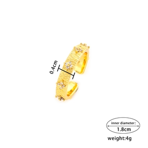 Vintage gold textured ring with flower zircon inlay shown on white background
