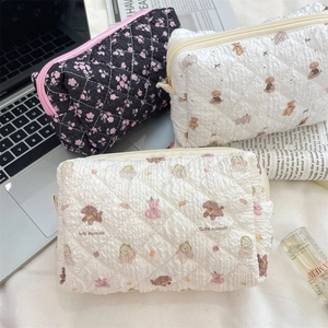 Quilted floral and animal print cosmetic bags with soft texture and zip closure