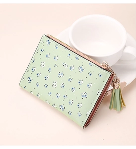 Close-up of floral print women short wallet with mint green tassels and metal zipper