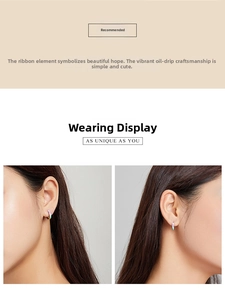 Close-up of rainbow striped colorful hoop earrings worn by an Asian female model