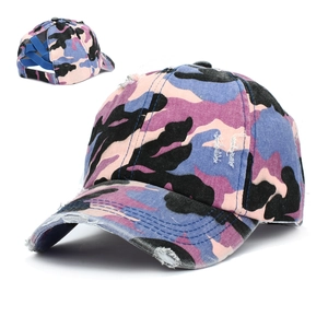 Detail of ponytail baseball cap featuring crisscross elastic bands and camo wash texture