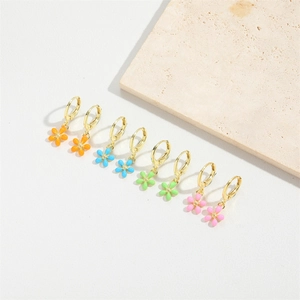 Close-up of colorful enamel flower earrings in orange, blue, green and pink with gold base