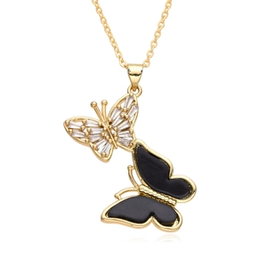 Detailed close-up of golden necklace with crystal butterfly and black enamel pendant