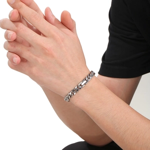 Mens silver stainless steel Cuban link bracelet on wrist with minimalist hip hop style