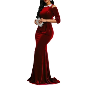 Detail of red velvet gown with white lace neckline and off-shoulder fishtail silhouette