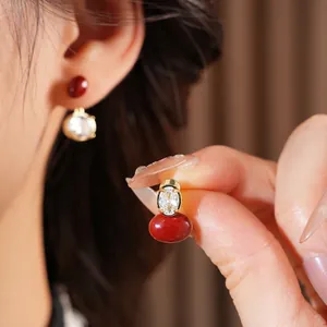 Vintage style oval earrings with red resin and clear zircon stones in gold finish