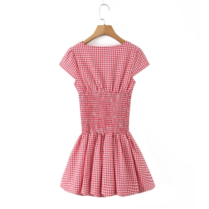 Detail of red and white gingham dress featuring elastic shirring at the back waist