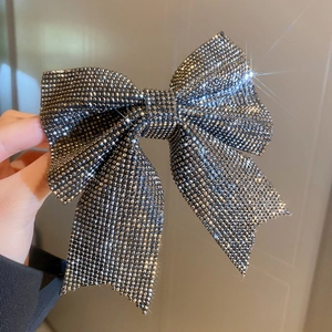 Close-up of sparkling dark grey rhinestone bow hair clip with luxury crystal detailing