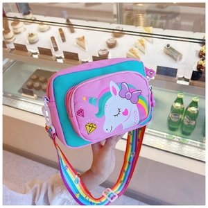 Detail of pink unicorn kids crossbody bag with rainbow strap and canvas texture