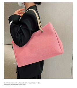 Pink canvas tote bag with woven rope handles shown on model in a side view profile
