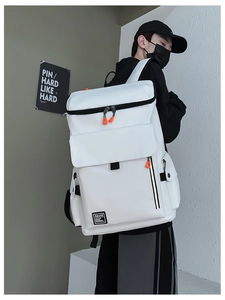 Detail of white large capacity travel backpack with orange zipper pullers and street style
