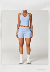 Detail of light blue yoga set featuring a racerback crop top and side drawstring shorts