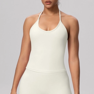 Detail of cross-back straps on creamy white yoga top with high-stretch athletic fabric