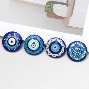 Detailed view of four 30mm blue evil eye glass pendants for DIY jewelry making