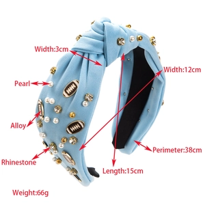 Close-up of sky blue knotted headband with white pearls and rugby-shaped alloy charms
