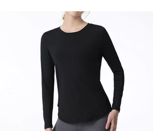 Detail of breathable long sleeve yoga top with slim fit cut and curved hemline design