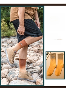 Detail of gradient orange tie-dye mid-tube cotton socks with AURORA embroidery detail