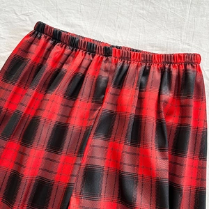 Women's faux silk red and black plaid pajama pants with elastic waist and flat lay detail