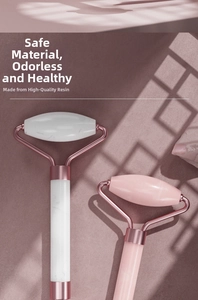 Detail of high-quality resin facial rollers in white marble and pink with rose gold metal