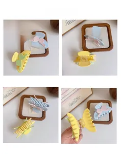 Macro detail of candy-colored bow hair claws with durable metal spring and acetate finish