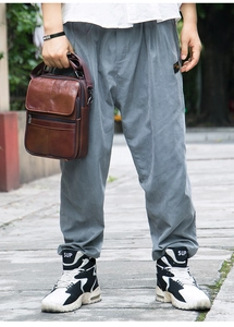 Brown litchi grain leather crossbody bag with multiple zipper compartments and magnetic flap