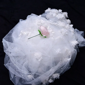 Close-up of white bridal veil with handmade 3D floral appliqués and pearl beads on mesh