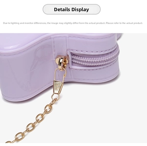 Close-up of lavender PVC bag with gold metal zipper and chain strap detail