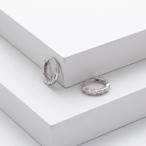 Detailed close-up of S925 silver bamboo-style stud earrings with sparkling cubic zirconia