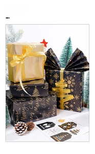 Detail of black and gold Merry Christmas wrapping paper with festive gift tags and ribbons