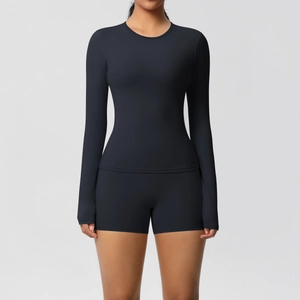 Detail of black long sleeve yoga top and high waist sports shorts with double-sided brushed fabric