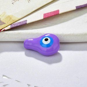 Close-up of a purple resin evil eye bead for DIY jewelry making accessories