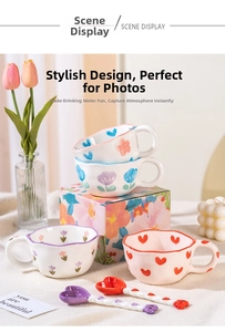 Detailed view of hand-pinched wavy ceramic mug with heart and flower painted patterns