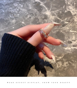 Detail of gold-plated double-layer ring with sparkling cubic zirconia on model's hand