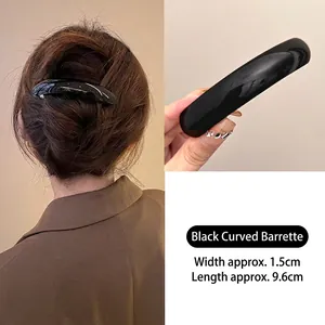 Glossy black arched spring hair clip 9.6cm for women showing back view and handheld detail