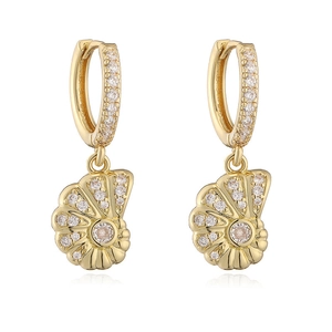Macro shot of 18K gold plated conch seashell drop earrings with sparkling cubic zirconia