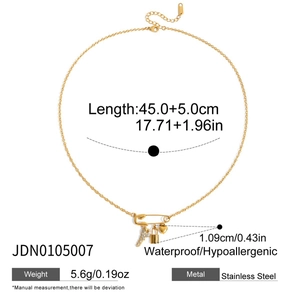 Detailed view of paperclip chain necklace with heart and lock charms and dimension specs