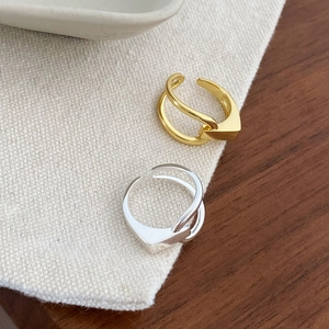 Detail of minimalist S925 silver open rings with gold and silver geometric cross design