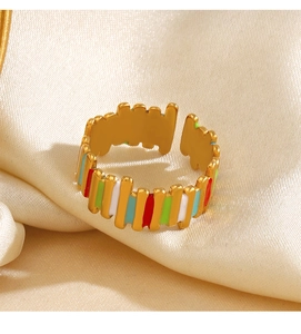 Detailed macro view of gold plated adjustable ring with vibrant colorful enamel stripes