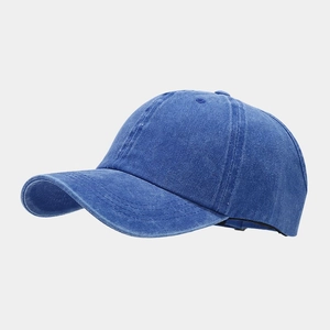 Detailed macro view of washed denim baseball cap fabric and reinforced brim stitching