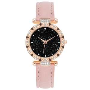 Close-up of rose gold hollow petal bezel watch with black starry dial and pink leather strap