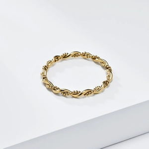 Minimalist golden braided twist ring with elegant woven texture on white background