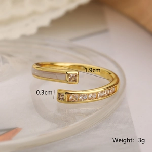 Macro detail of 18K gold-plated ring with white shell inlay and zircon stones