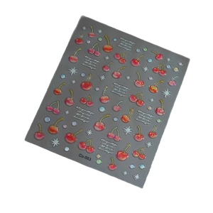 Glitter cherry nail art stickers with red fruits and white stars on dark background