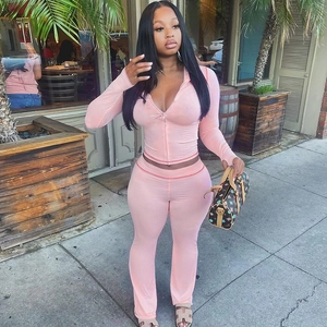 Outdoor shot of a pink velvet hooded cardigan and high-waist slim pants set